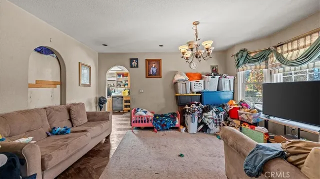 a living room with furniture toys and a flat screen tv