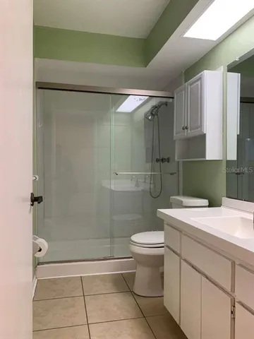 a bathroom with a shower a toilet and sink