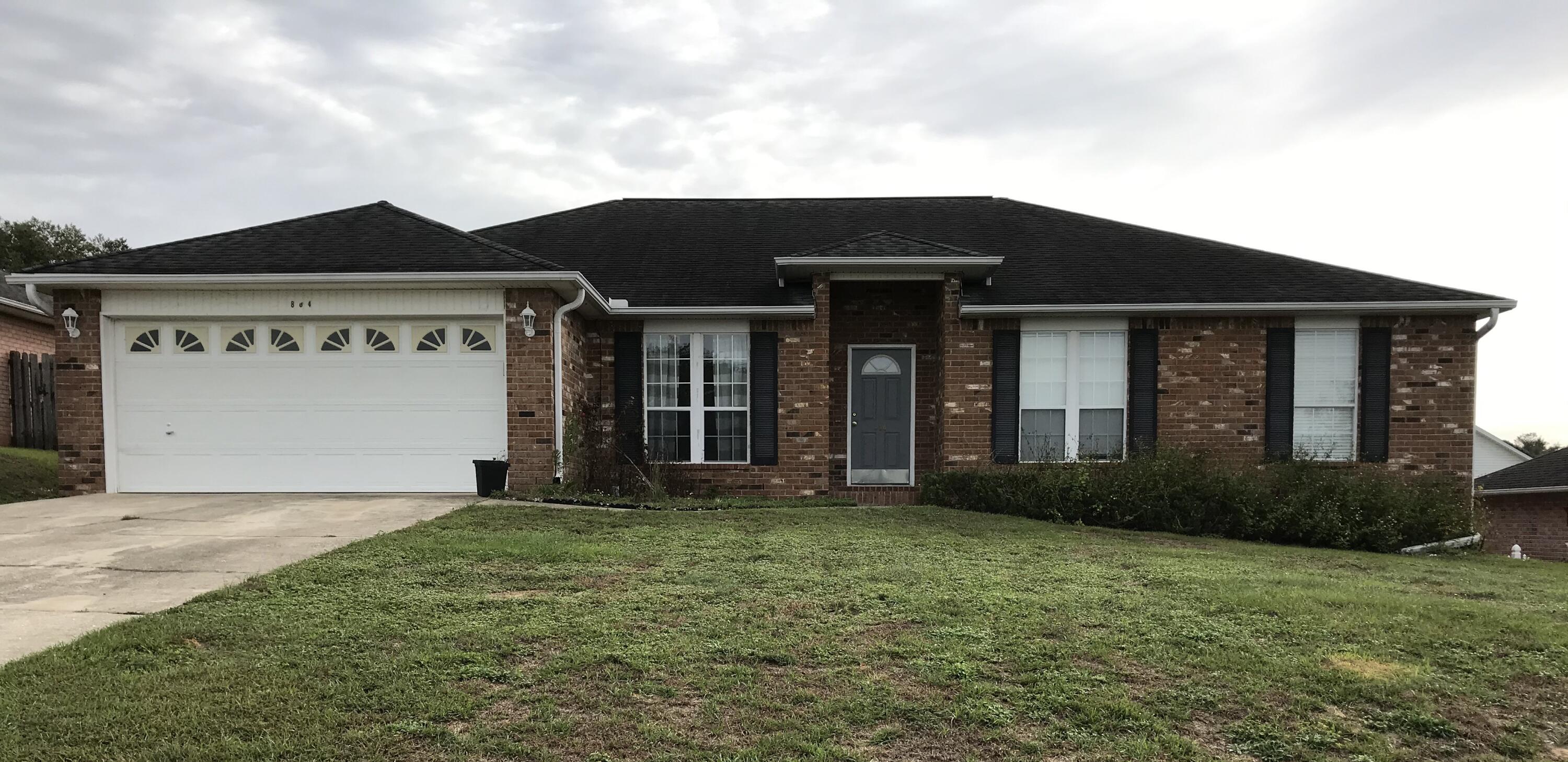 804 Travis Court Crestview, FL 32536 - Photo 1 of 33 a front view of a house with garden