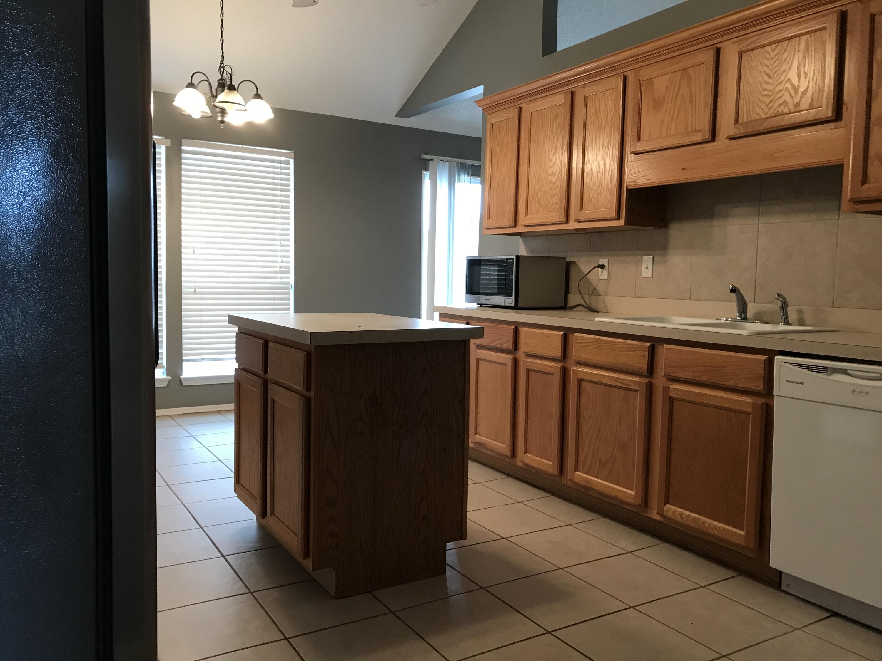804 Travis Court Crestview, FL 32536 - Photo 11 of 33 a kitchen with stainless steel appliances granite countertop a sink stove and cabinets