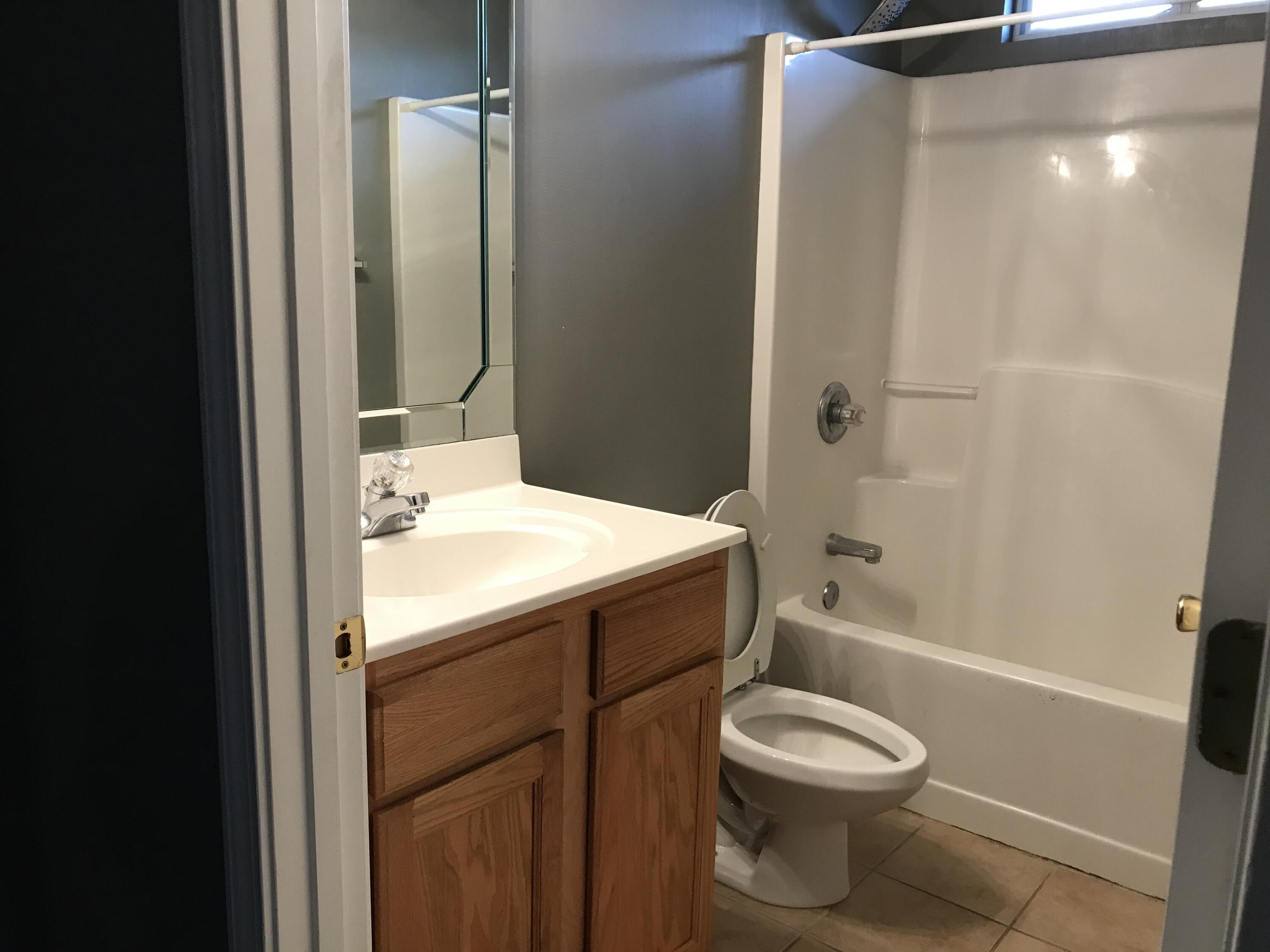 804 Travis Court Crestview, FL 32536 - Photo 19 of 33 a bathroom with a sink toilet and shower