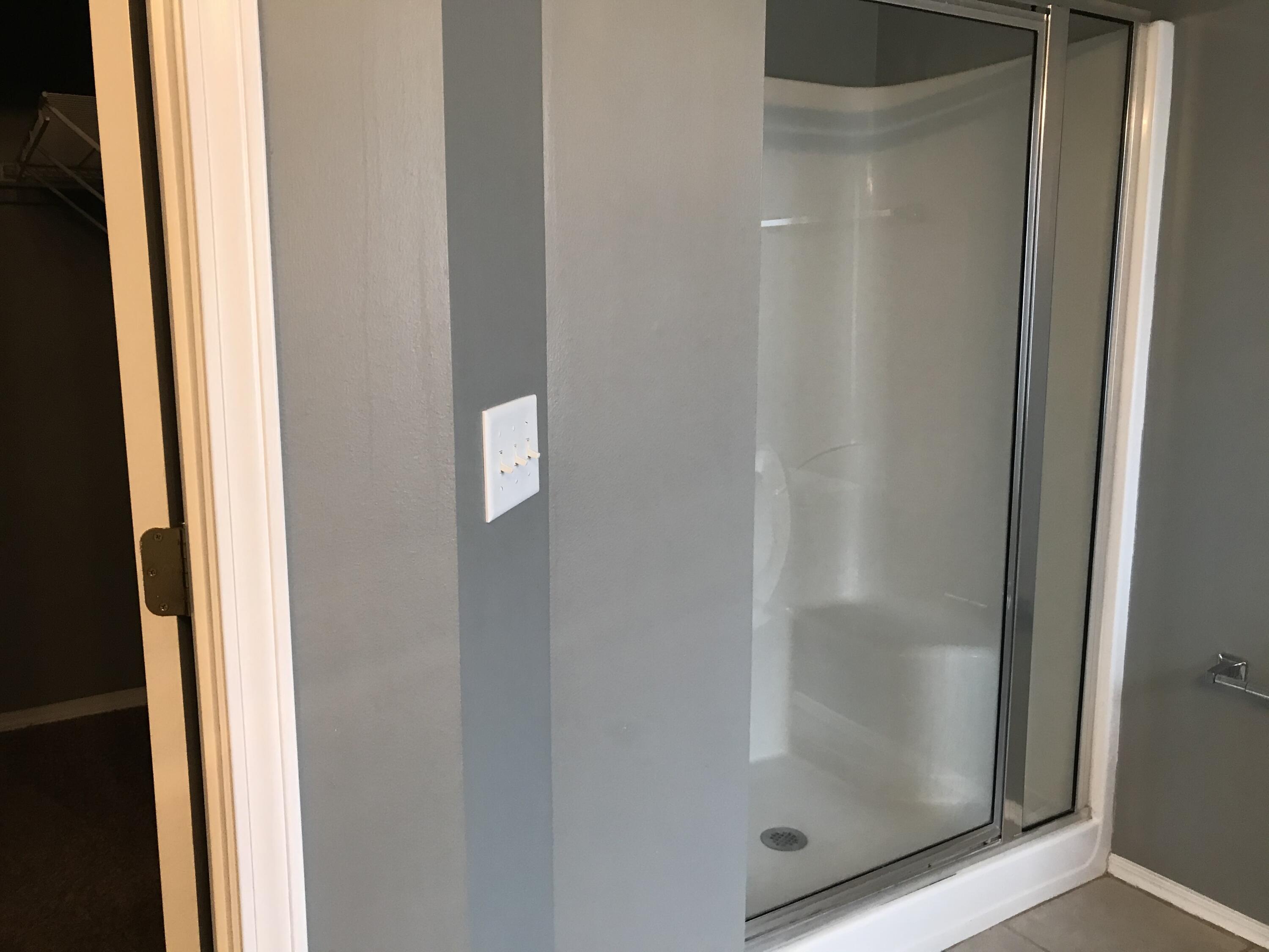 804 Travis Court Crestview, FL 32536 - Photo 20 of 33 a bathroom with a glass shower door