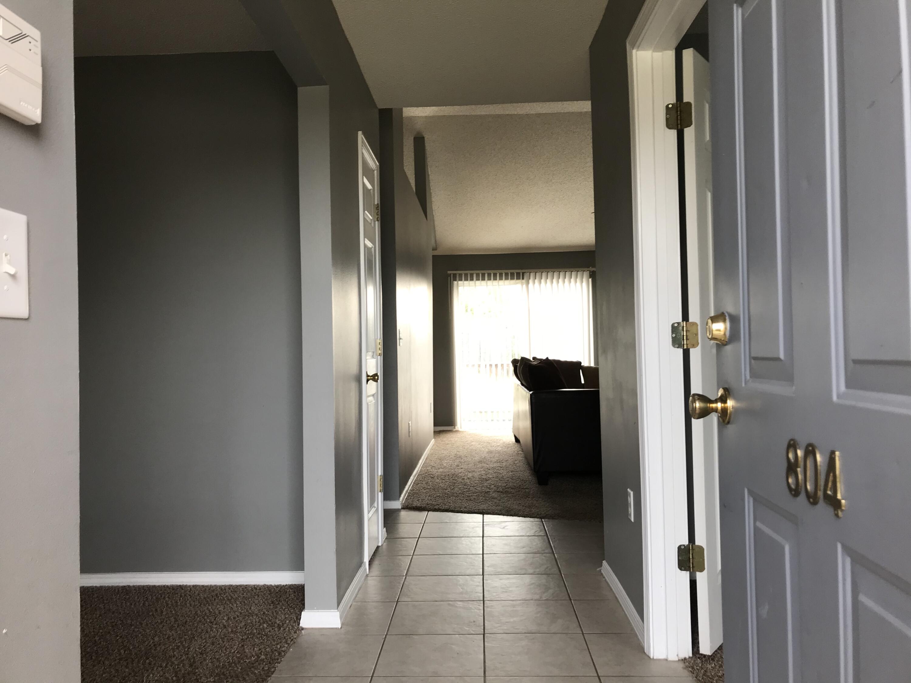 804 Travis Court Crestview, FL 32536 - Photo 3 of 33 a view of a hallway with wooden shelves