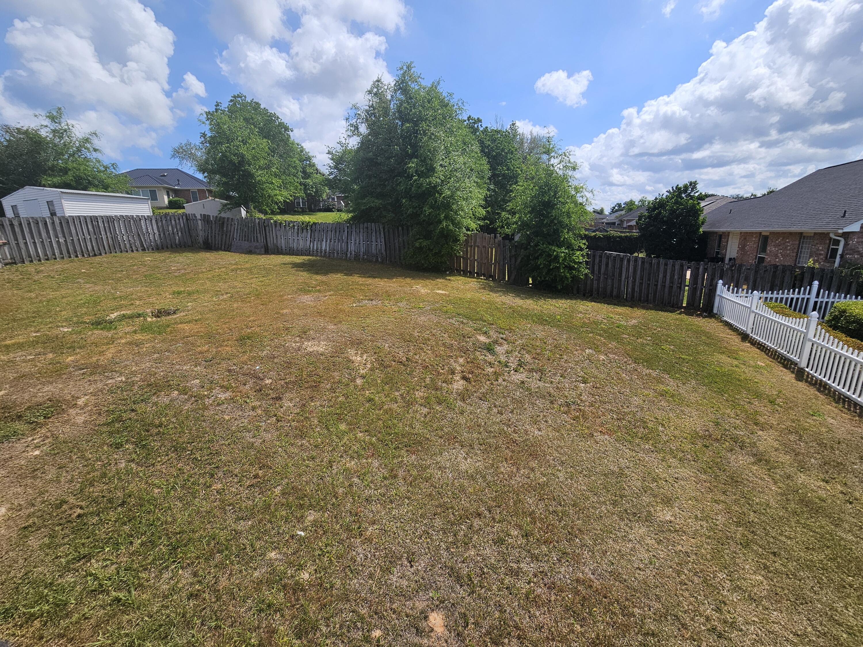 804 Travis Court Crestview, FL 32536 - Photo 32 of 33 a view of a swimming pool with a yard