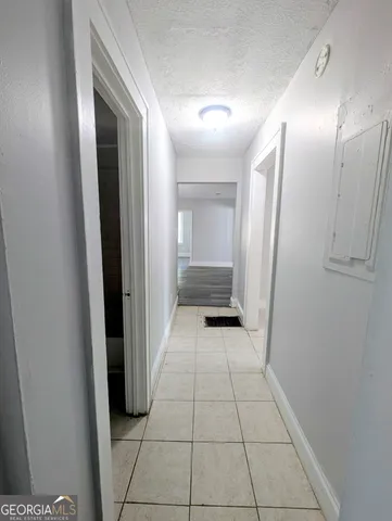 a view of a hallway to closet and wooden floor