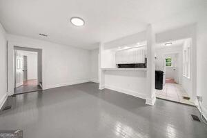 260 Patterson Avenue Southeast, Unit A Atlanta, GA 30316 - Photo 15 of 16 an empty room with wooden floor and windows