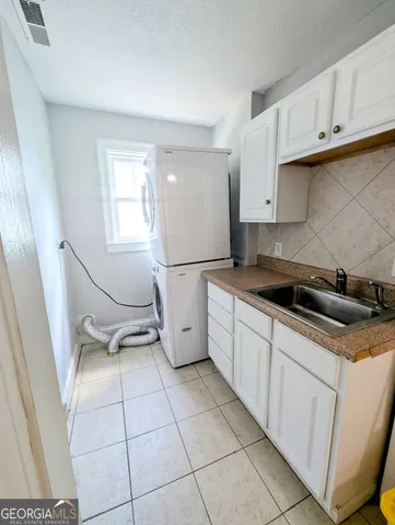 a kitchen with a sink a stove and cabinets