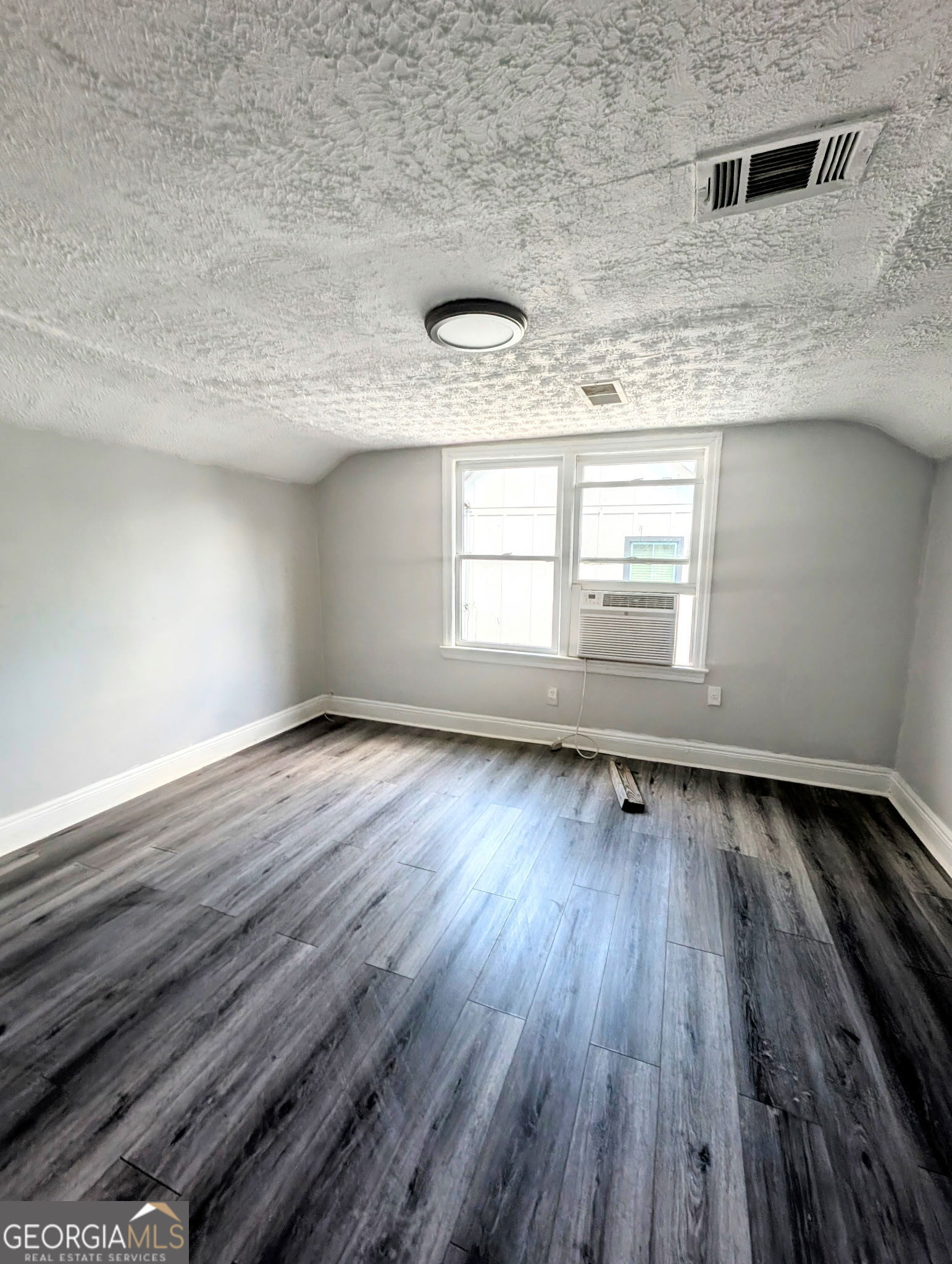 260 Patterson Avenue Southeast, Unit A Atlanta, GA 30316 - Photo 8 of 16 an empty room with wooden floor and windows