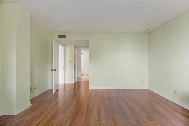 a view of a room with wooden floor