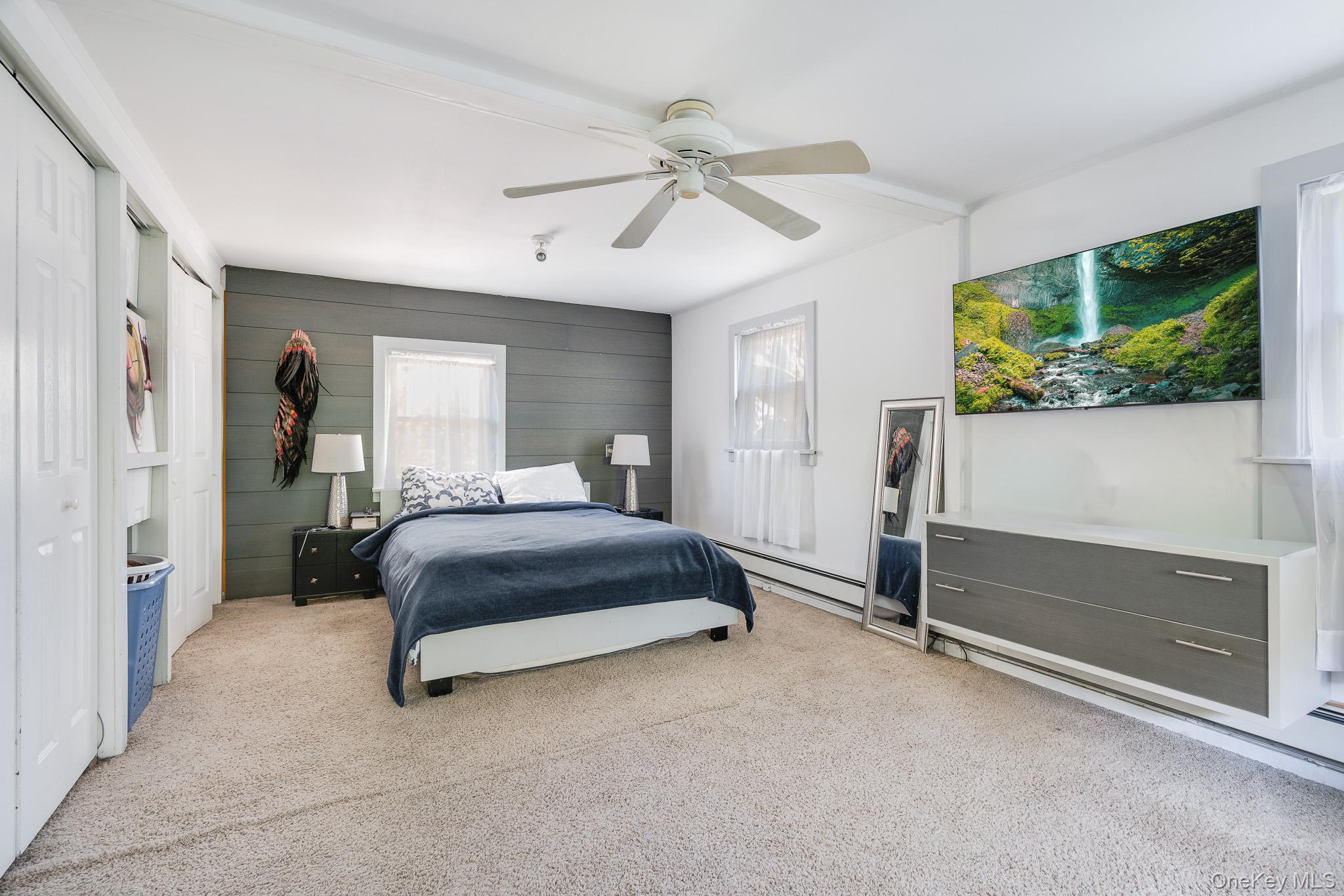 553 Hosner Mountain Road Stormville, NY 12582 - Photo 12 of 36 a bedroom with a bed and a flat screen tv