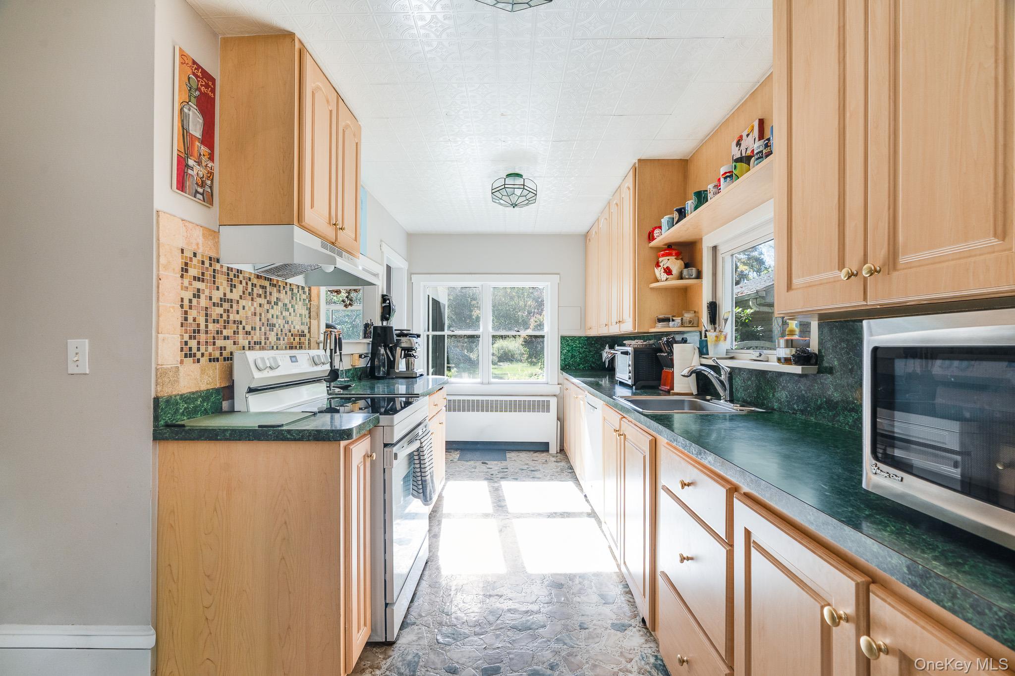 553 Hosner Mountain Road Stormville, NY 12582 - Photo 16 of 36 a kitchen with stainless steel appliances granite countertop a sink and cabinets