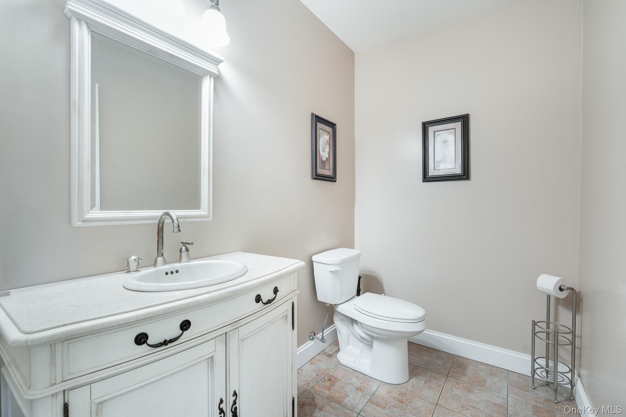 553 Hosner Mountain Road Stormville, NY 12582 - Photo 32 of 36 a bathroom with a toilet a sink and mirror