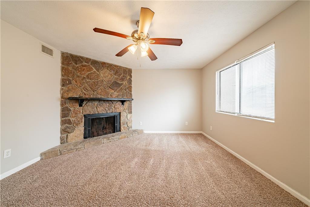 5175 Walker Road Stone Mountain, GA 30088 - Photo 11 of 37 an empty room with windows and fireplace