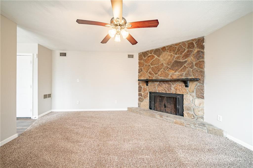 5175 Walker Road Stone Mountain, GA 30088 - Photo 12 of 37 a view of empty room with fan and fireplace