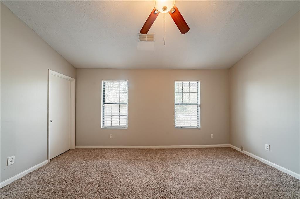 5175 Walker Road Stone Mountain, GA 30088 - Photo 13 of 37 an empty room with closet and windows