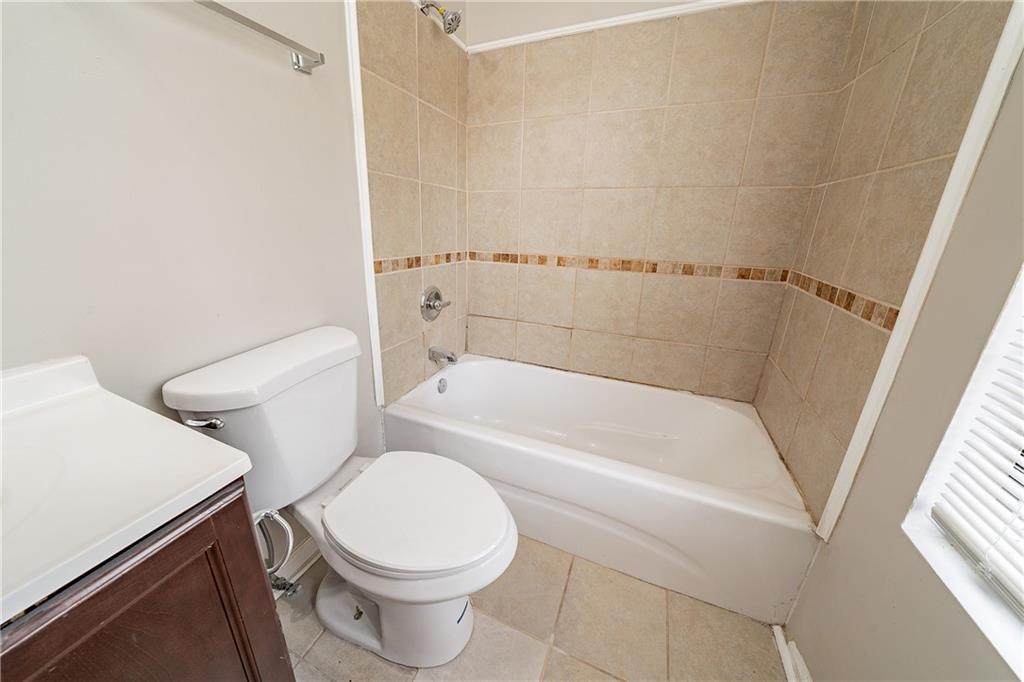 5175 Walker Road Stone Mountain, GA 30088 - Photo 17 of 37 a white toilet sitting next to a bath tub