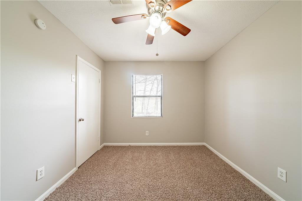 5175 Walker Road Stone Mountain, GA 30088 - Photo 21 of 37 an empty room with a window and a fan