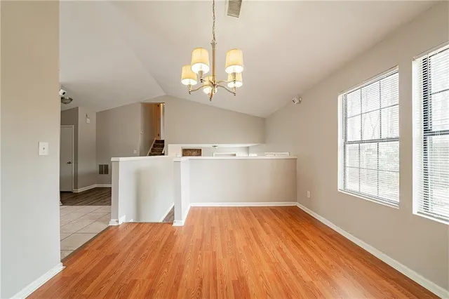 a view of a room with wooden floor and a window