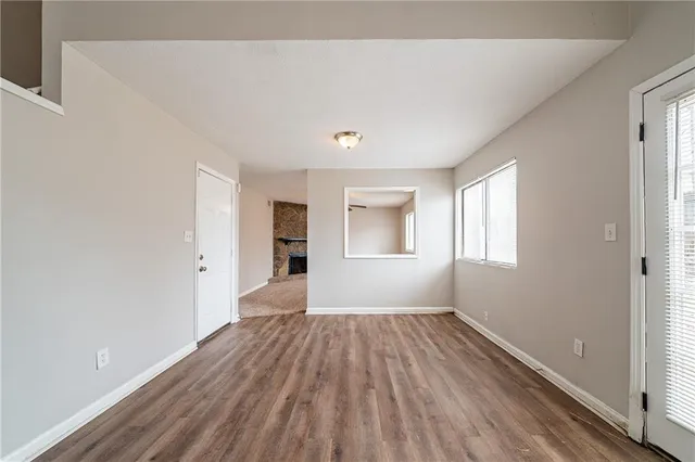 a view of a room with wooden floor and windows