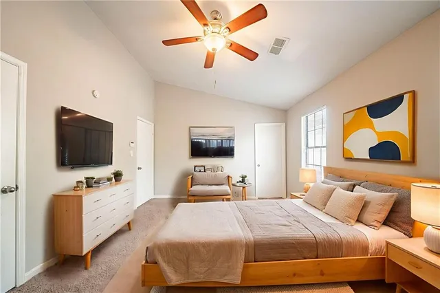 a bedroom with a bed and a flat screen tv