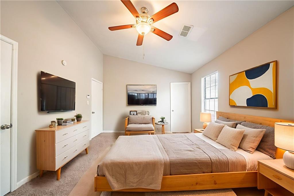 5175 Walker Road Stone Mountain, GA 30088 - Photo 5 of 37 a bedroom with a bed and a flat screen tv