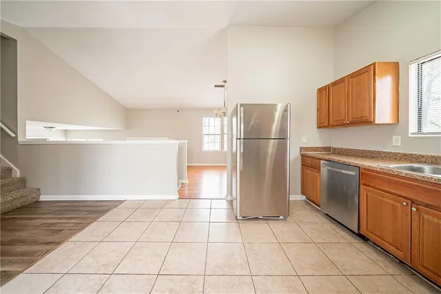 a kitchen with a stove a refrigerator and a sink