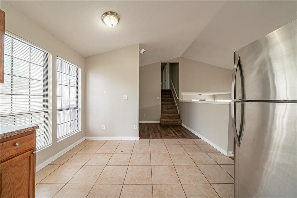 5175 Walker Road Stone Mountain, GA 30088 - Photo 9 of 37 a view of a refrigerator in kitchen and entryway with wooden floor