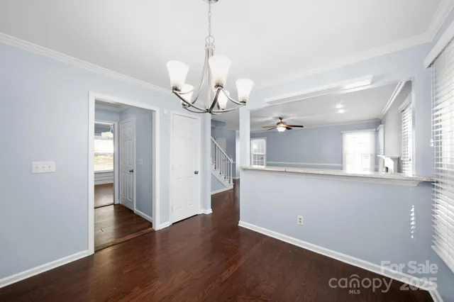a view of a kitchen with wooden floor and a window