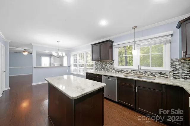 a kitchen with granite countertop a stove and a sink