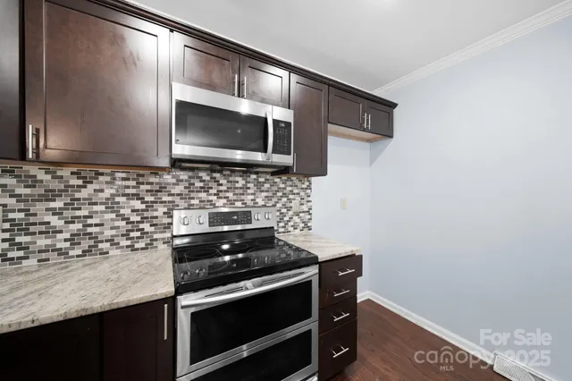 a kitchen with a stove microwave and sink