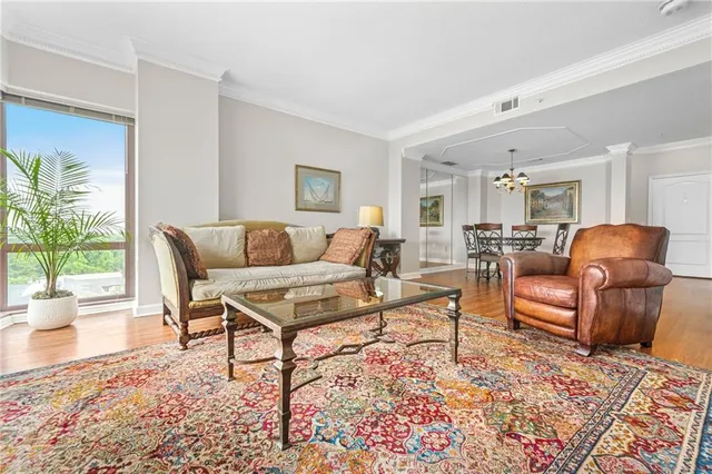 a living room with furniture and a potted plant