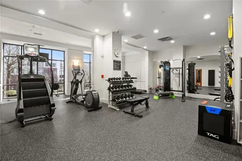 a room with gym equipment and a large window