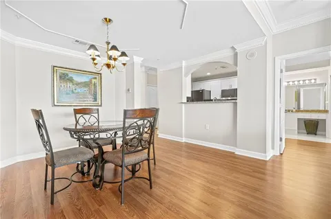 a view of a dining room with furniture wooden floor and chandelier