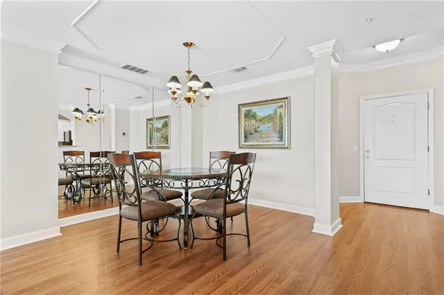 a view of a dining room with furniture wooden floor and chandelier