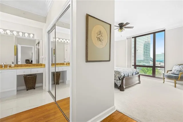 a living room with furniture a large window and wooden floor
