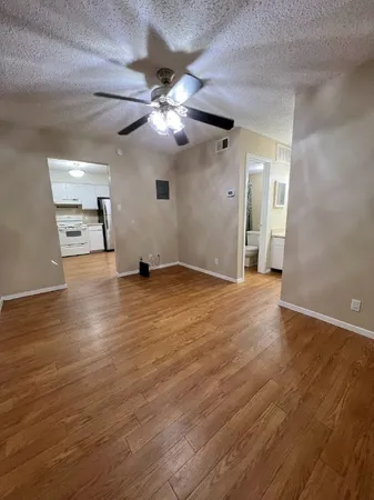a view of empty room with wooden floor