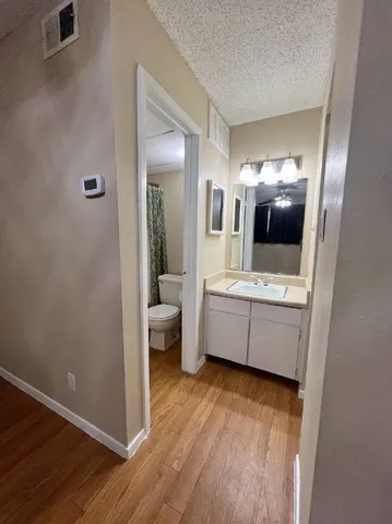 a bathroom with a sink mirror and vanity