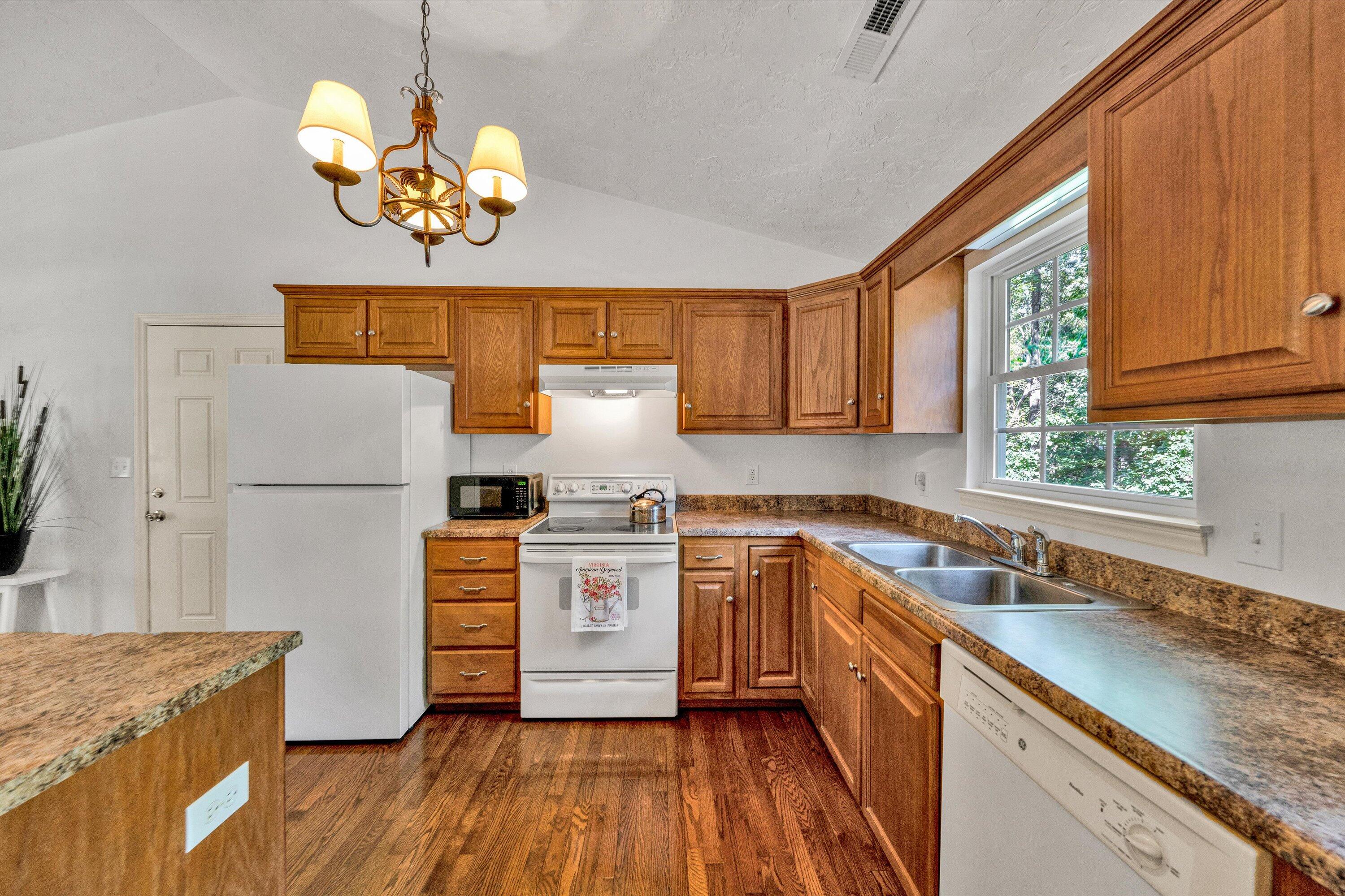 801 Indian Ridge Drive Moneta, VA 24121 - Photo 13 of 36 a kitchen with stainless steel appliances granite countertop wooden cabinets a stove a sink and dishwasher