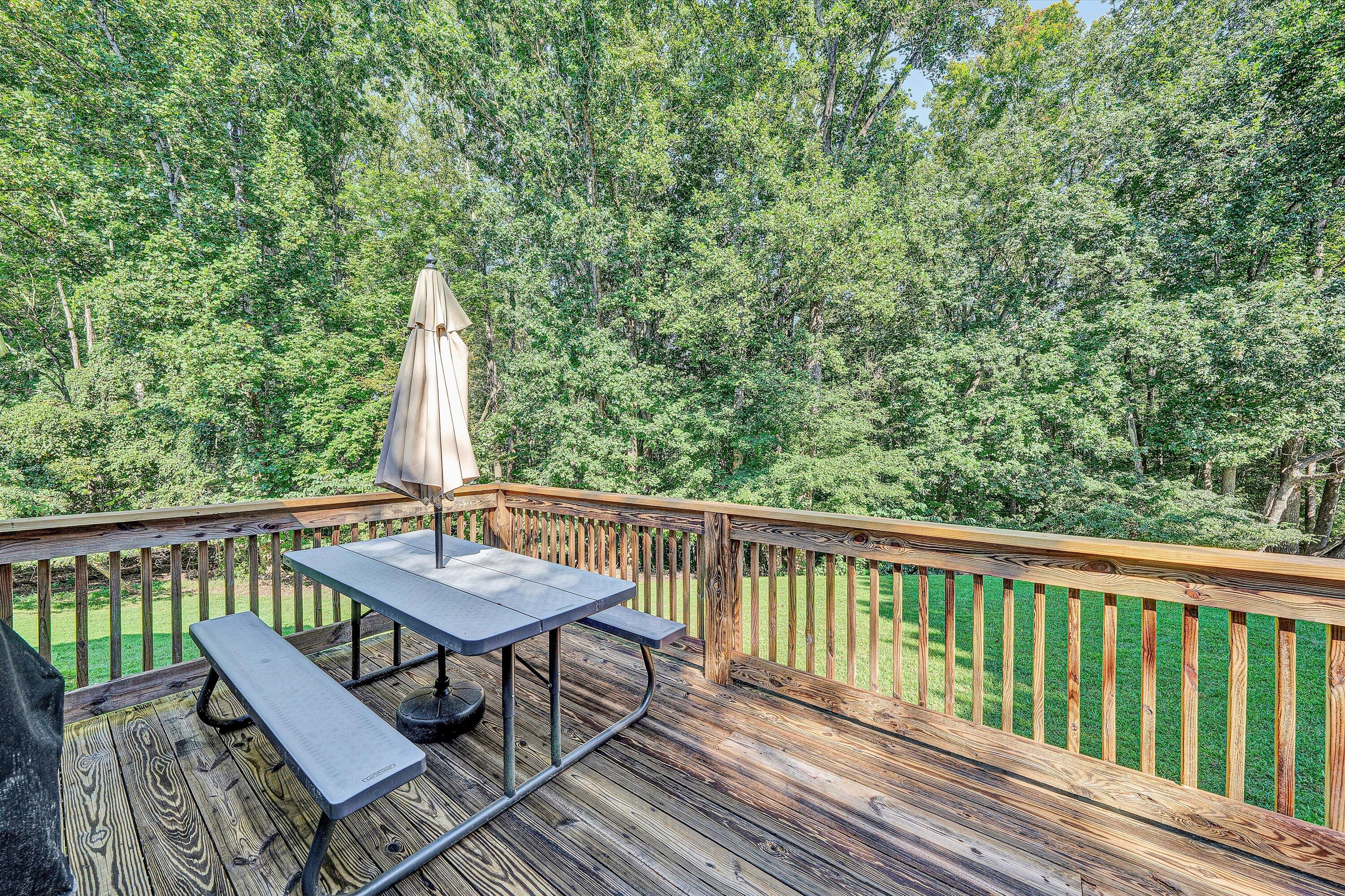 801 Indian Ridge Drive Moneta, VA 24121 - Photo 16 of 36 a view of a balcony with wooden floor and outdoor seating