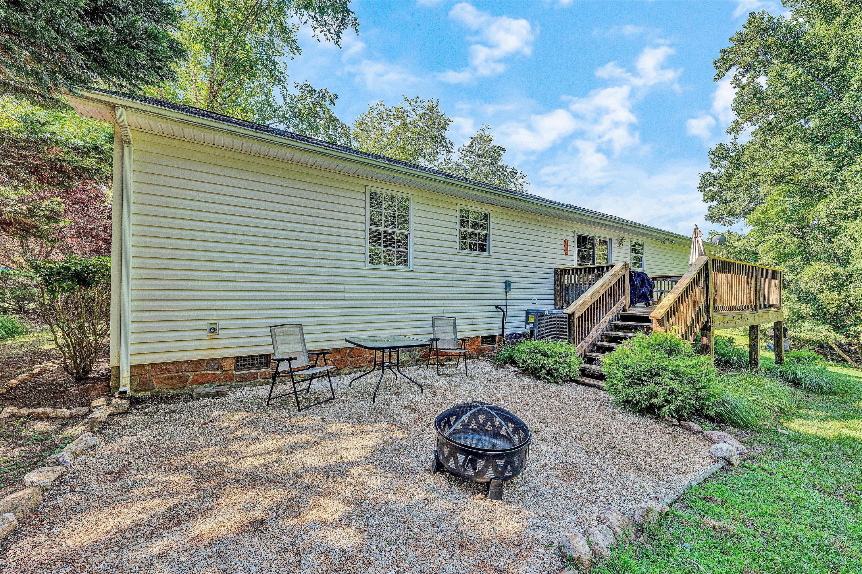 801 Indian Ridge Drive Moneta, VA 24121 - Photo 18 of 36 a backyard of a house with table and chairs