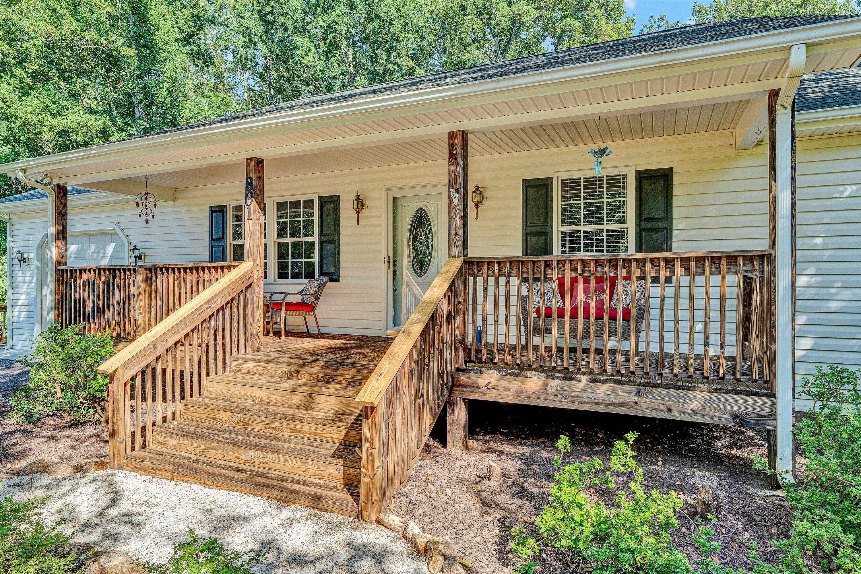 801 Indian Ridge Drive Moneta, VA 24121 - Photo 6 of 36 a view of a deck with a large window and wooden fence