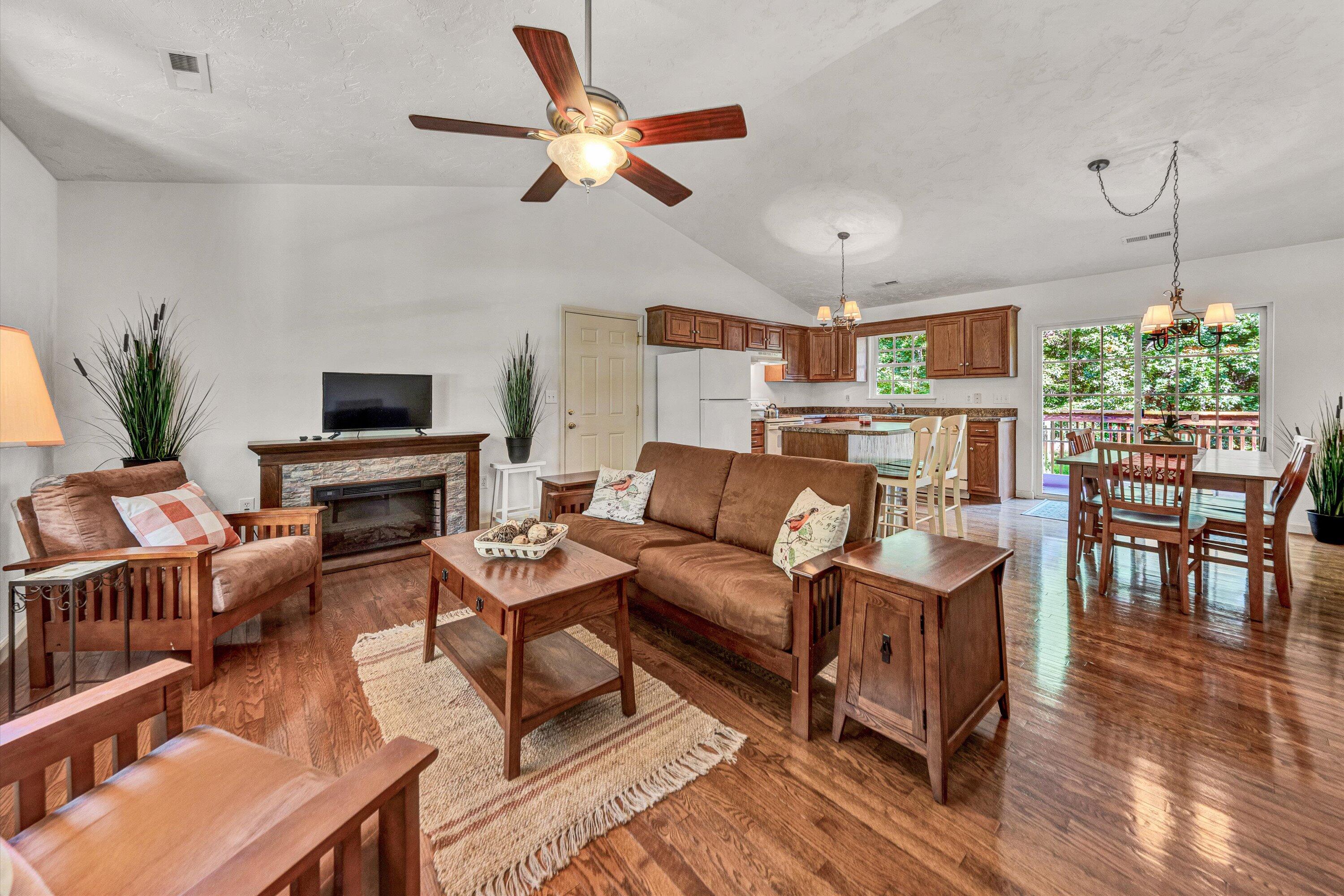 801 Indian Ridge Drive Moneta, VA 24121 - Photo 10 of 36 a living room with furniture a fireplace and a flat screen tv
