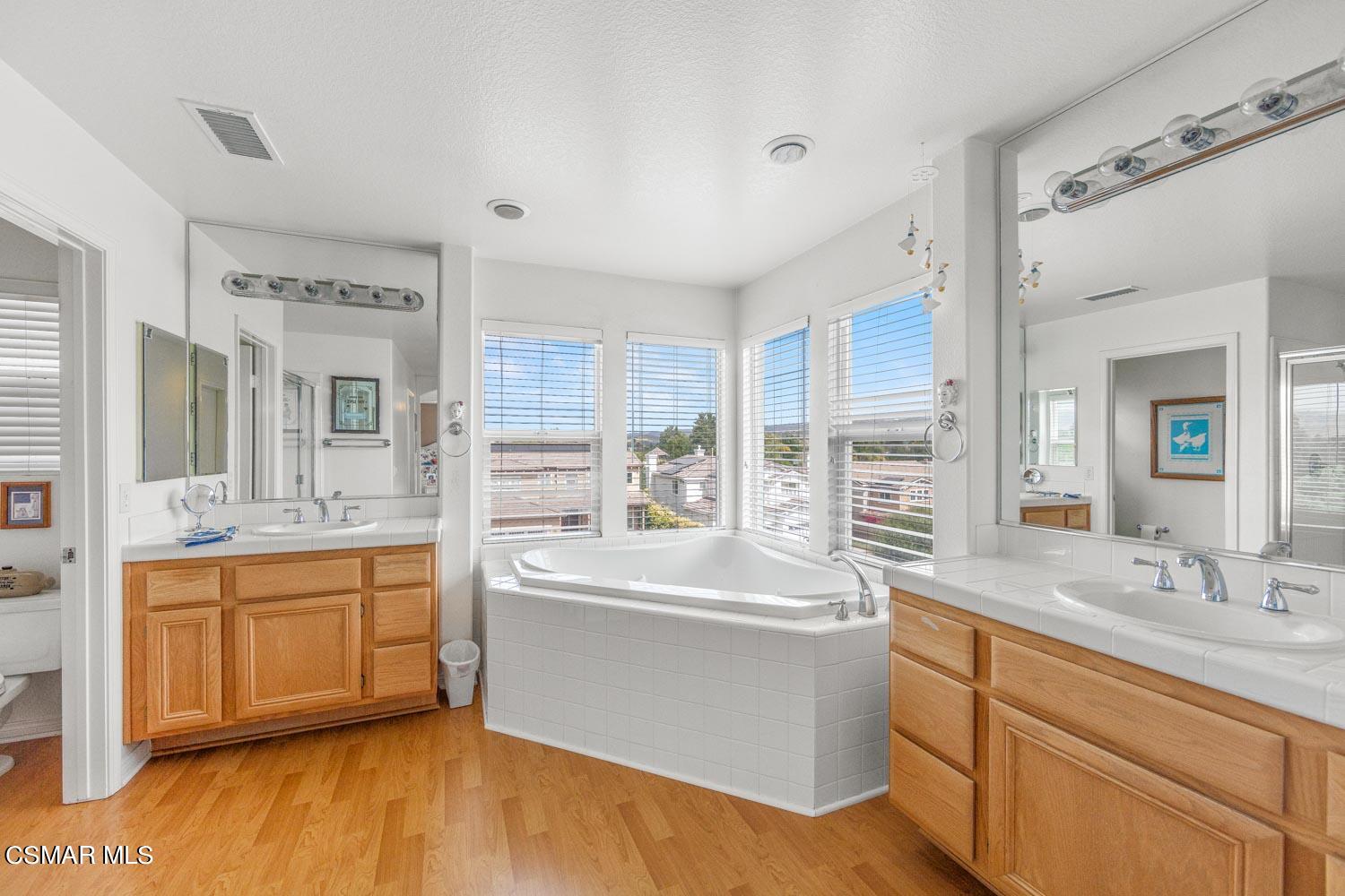 3453 Almond Tree Court Simi Valley, CA 93065 - Photo 14 of 20 a large bathroom with double vanity and a large mirror