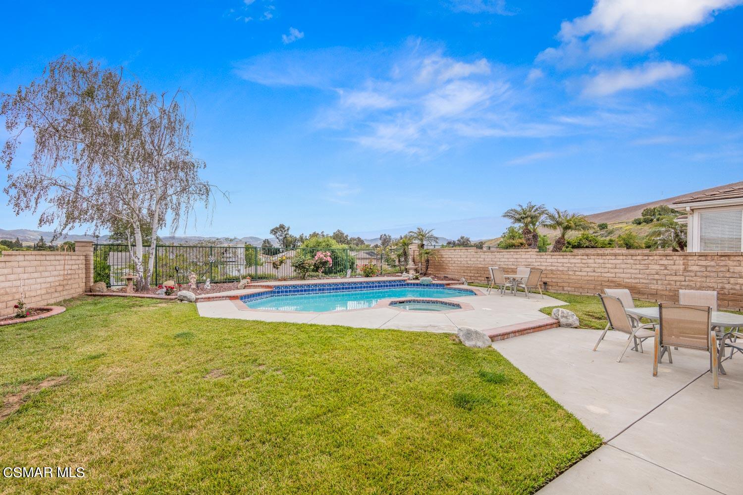 3453 Almond Tree Court Simi Valley, CA 93065 - Photo 17 of 20 a view of a swimming pool with an outdoor seating and a yard