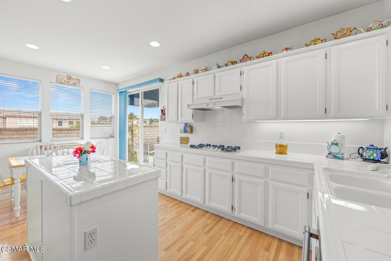 3453 Almond Tree Court Simi Valley, CA 93065 - Photo 9 of 20 a kitchen with granite countertop a sink dishwasher stove and cabinets
