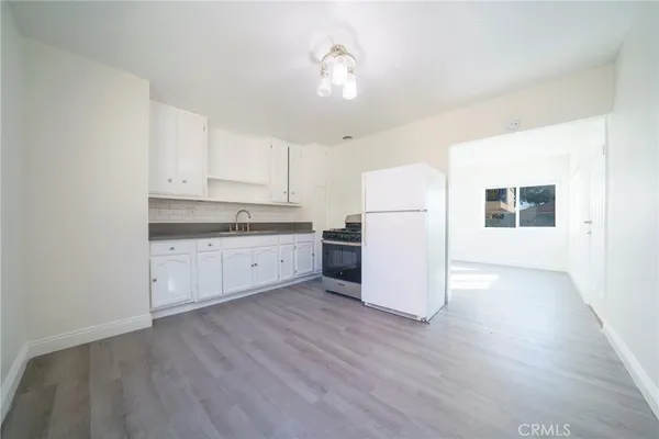 a view of a kitchen with wooden floor