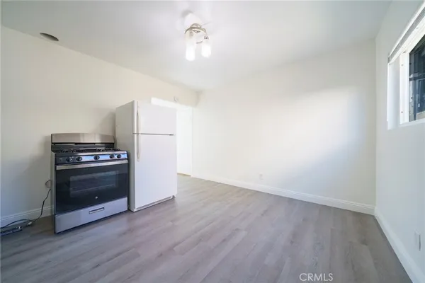 a view of kitchen with wooden floor and electronic appliances