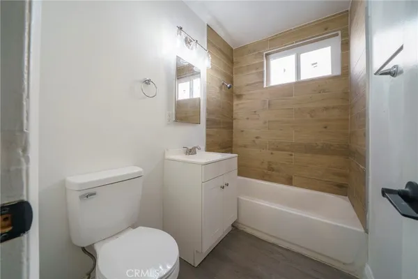 a bathroom with a toilet a sink and bathtub