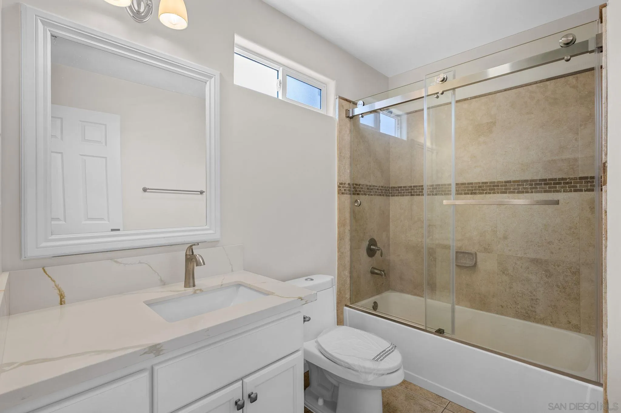 1749-51 Dahlia Avenue San Diego, CA 92154 - Photo 14 of 23 a bathroom with a sink toilet and shower