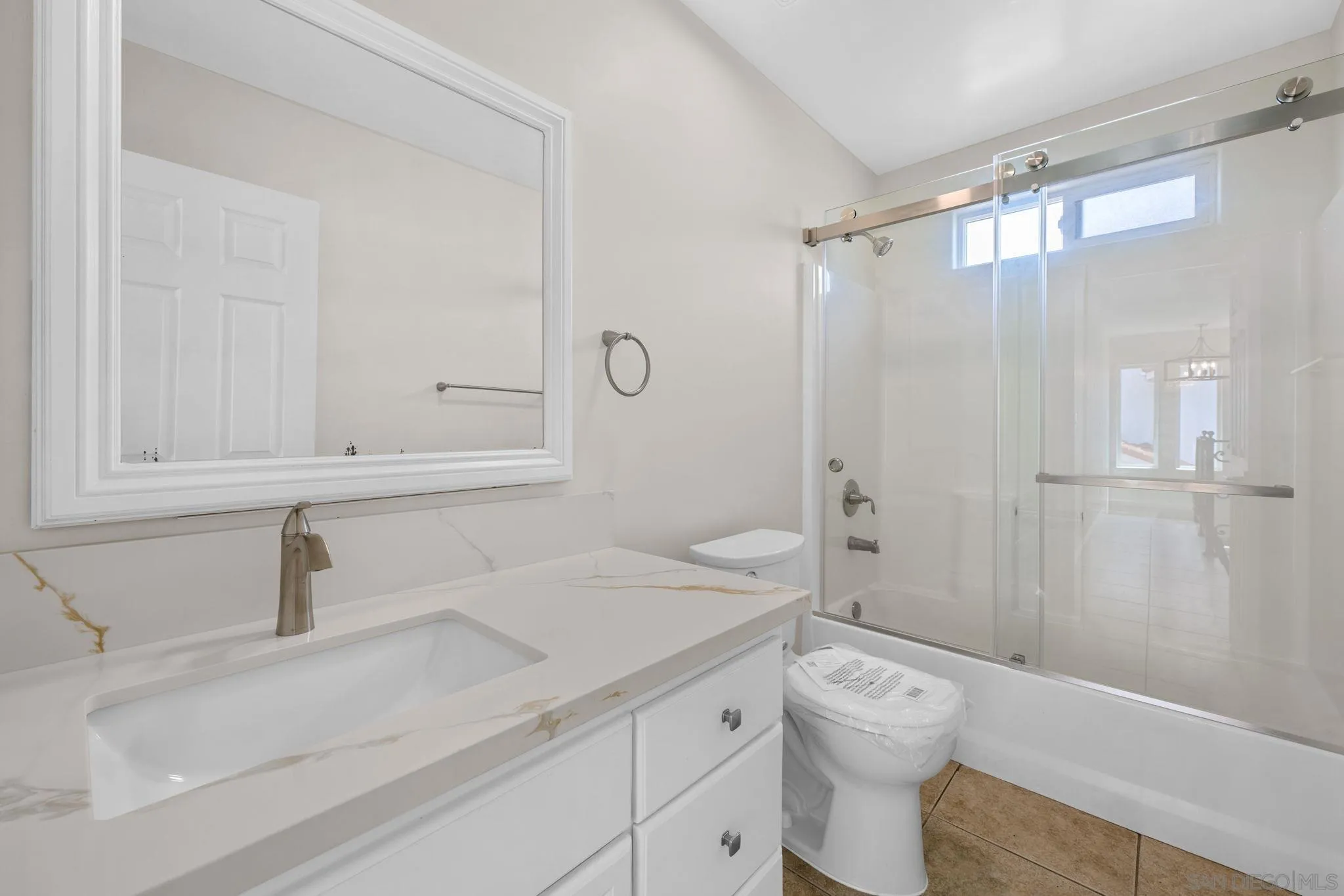 1749-51 Dahlia Avenue San Diego, CA 92154 - Photo 16 of 23 a bathroom with a sink toilet and shower